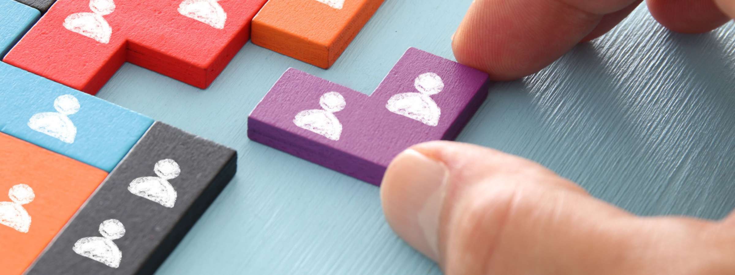 image of tangram puzzle blocks with people icons over wooden table ,human resources and management concept