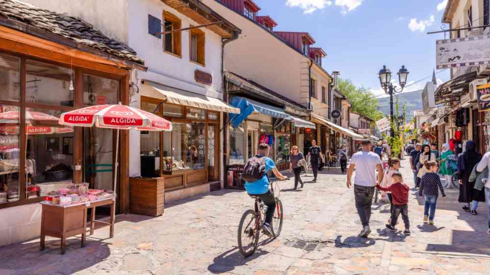Old Bazaar street with pedestrians and bicyclists in Skopje, North Macedonia