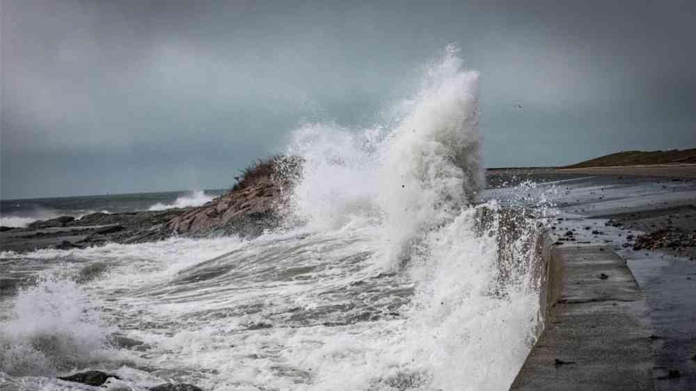 Waves and storm surge crash over Ocean Drive in Newport Rhode Island, USA