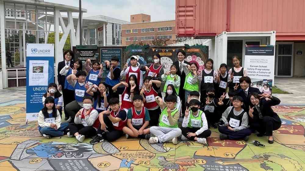 Group photo of children at the a life-size Riskland game in Hwangseong Republic of Korea